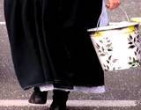 Amish women carrying bucket