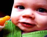 photo of a happy baby with bottle full of fennel tea