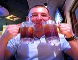 photo of a guy holding two glasses of blackberry tea