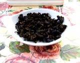 photo of a bowl full of dried black tea leaves