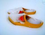 photo of a pair of slippers covered with snow a natural remedy for cold feet