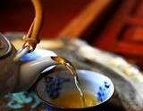 photo of herbal tea pot pouring a cup of herbal tea as an excellent source for natural hair loss
