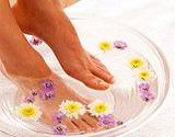 photo of woman soak feet in medicinal chamomile tea