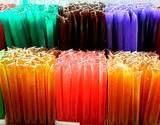 A photo of a display of honeysticks in various colors