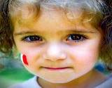 Little Italian girl with Italian flag painted on her cheek