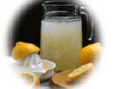 tall pitcher of lemon aid and cut lemons
