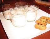 photo of 4 glasses of milk and chocolate chip cookies