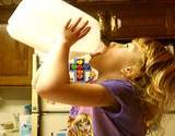;Little girl drinking milk from a gallon jug