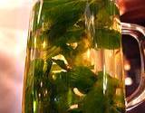 photo of a canning jar full of peppermint tea and peppermint leaves