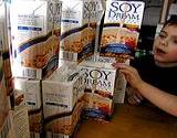 photo of a boy with a large display of soy dream milk a natural source as menopause remedy