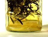photo of a jar of herbal vinegar with rosemary and lemon