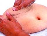 photo of two hands kneading dough shaped like a stomach with bellybutton massaging stomach relieves flatulence
