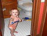 A toddler scrubbing the floor with spongemop for vinegar cleaning