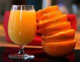 photo of a stack of orange peels beside a glass of orange juice for natural allergy relief