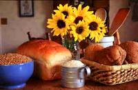 photo of a table full of breads, rice, grains and sunflowers