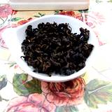 photo of a bowl full of dried black tea leaves