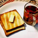 photo of a cup of black tea with buttered toast