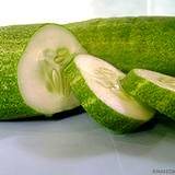 photo of a fresh cucumber being sliced a natural remedy for sunburn relief