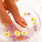 photo of woman soak feet in medicinal chamomile tea