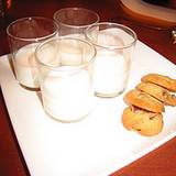 photo of 4 glasses of milk and chocolate chip cookies