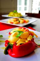photo of a red pepper stuffed with cooked pasta and cheese