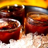 photo of 3 glasses filled with rose hip tea sitting in a bowl of ice