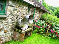photo of a beautiful cottage with wash tubs sitting along side to take a milk bath to expel tapeworms