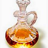 A cruet half filled with apple cider vinegar