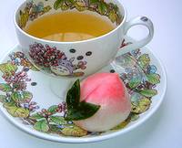 photo of a beautiful cup of chamomile tea with a edible rose on the side