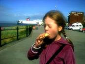 photo of a young girl suffering from a headache from eating ice cream