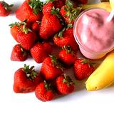 picture of strawberries, bananas, and cup of yogurt 