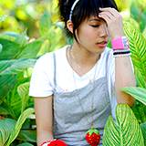 photo of a young lady working in her garden and showing signs of allergy headache
